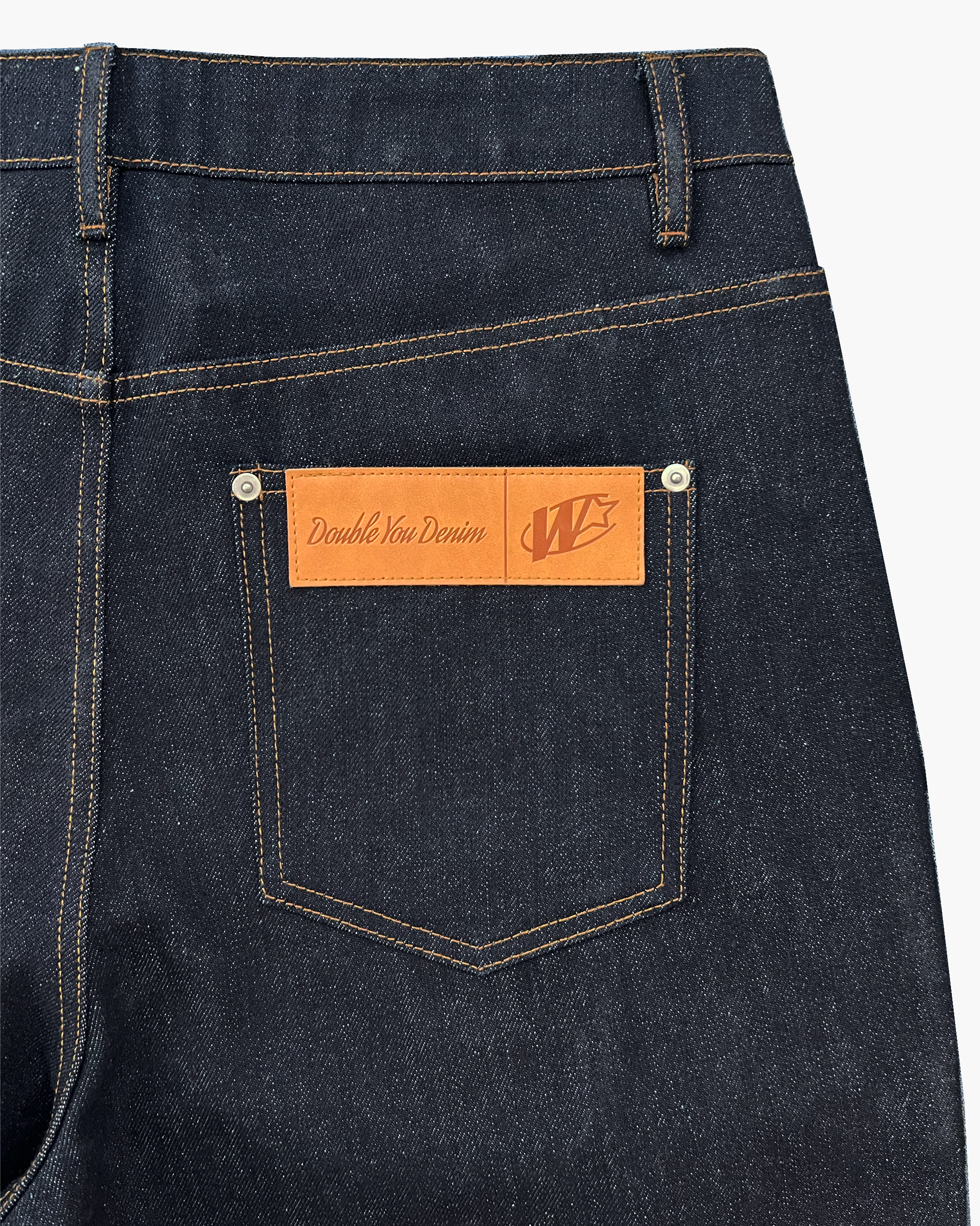 PLEATED RAW DENIM JEANS